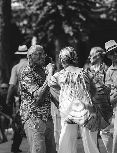 human grayscale photo of a man and woman dancing person
