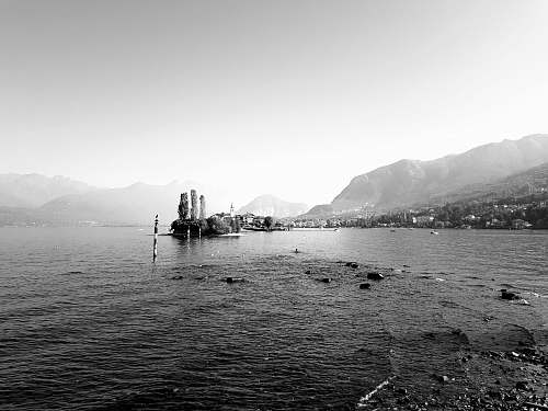 nature grayscale photo of body of water isola bella