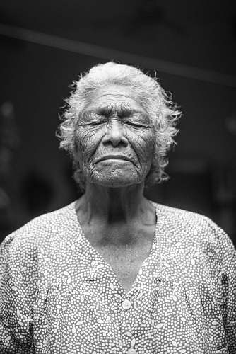 portrait grayscale photo of closed-eyes woman elderly
