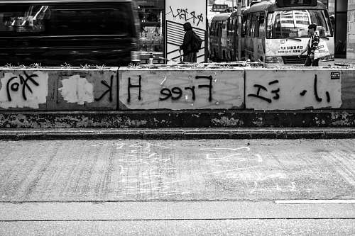 human grayscale photo of concrete street person