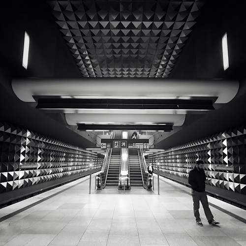 subway grayscale photo of escalator train