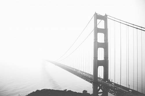 bridge grayscale photo of Golden Gate Bridge fog