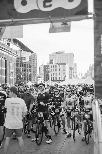 human grayscale photo of group of cyclist person