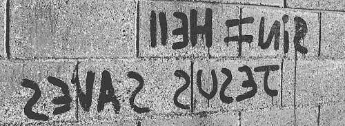 grey grayscale photo of hollow blocks wall with Jesus Saves text herne bay