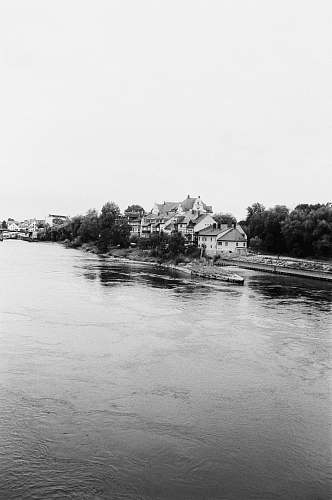 water grayscale photo of houses beside river nature