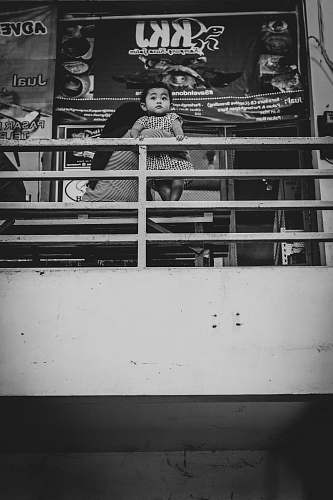surabaya grayscale photo of man holding baby while sitting on sofa indonesia