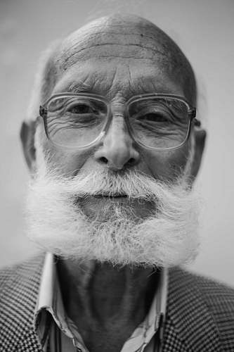 people grayscale photo of man wearing eyeglasses human
