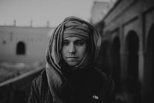 apparel grayscale photo of man wearing headscarf clothing