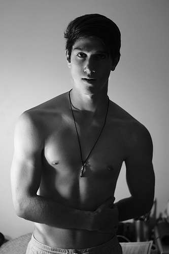 person grayscale photo of man wearing white bottoms human