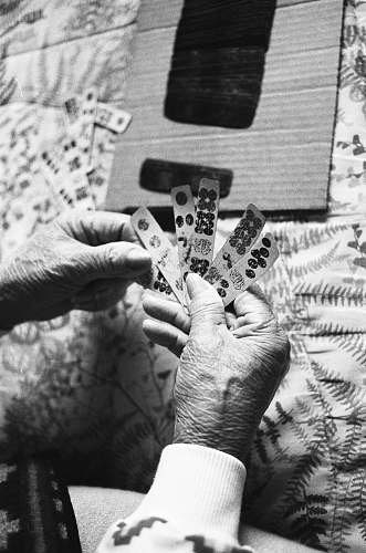 grey grayscale photo of person holding game chips human