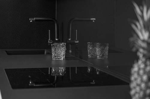 black grayscale photo of two rocks glass near sink kitchen