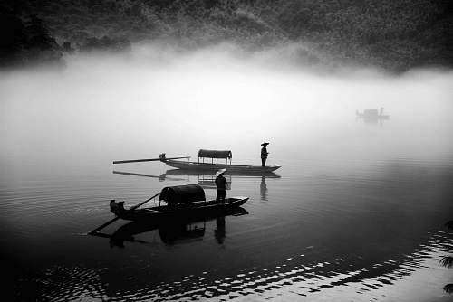 boat grayscale photo of two row boats lake