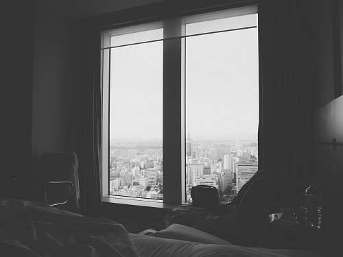 chair grayscale photo of window bedroom