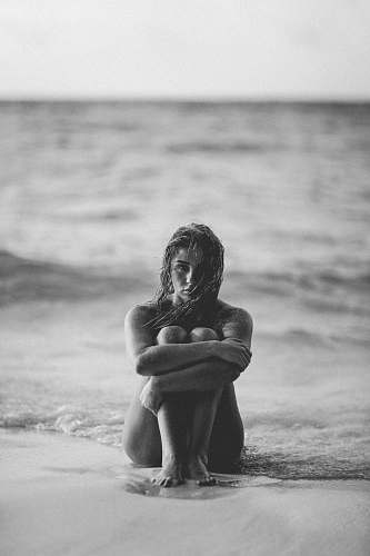 woman grayscale photo of woman on seashore people