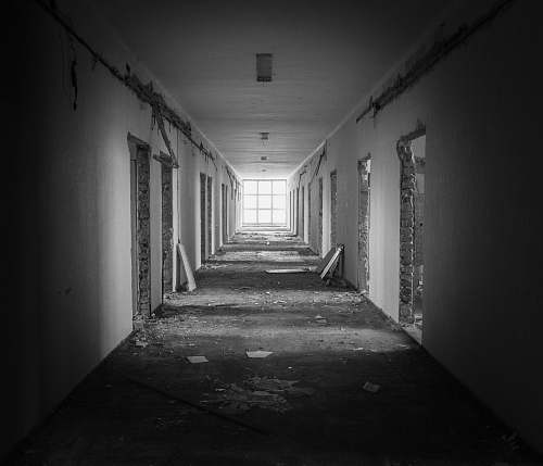 corridor grayscale photography of abandoned building flooring