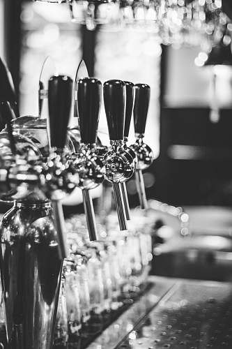 glass grayscale photography of beer tap handle grand café de keizer