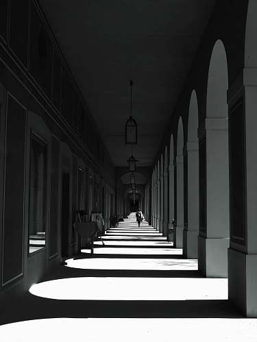 corridor grayscale photography of building floor