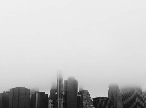 nature grayscale photography of buildings smoke