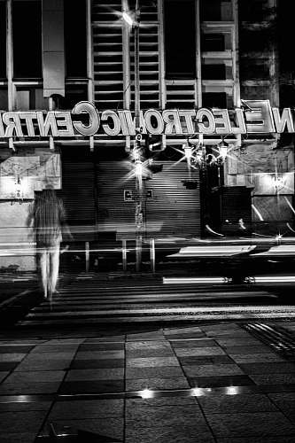 human grayscale photography of closed building person