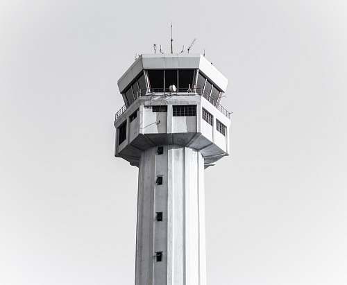 building grayscale photography of concrete tower tower
