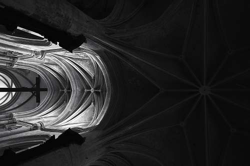 architecture grayscale photography of crucifix placed inside cathedral lyon