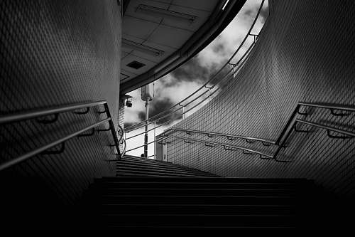 grey grayscale photography of empty stairs tunnel