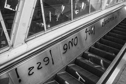 banister grayscale photography of escalator handrail