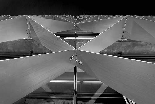 wood grayscale photography of frame triangle