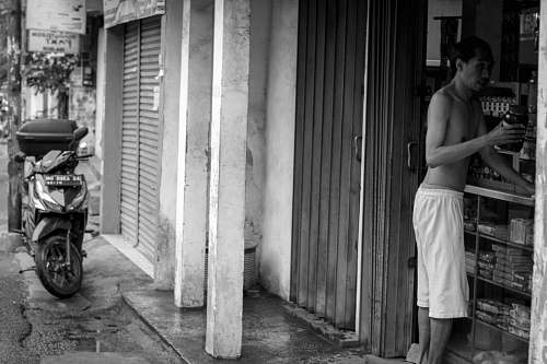 apparel grayscale photography of half naked man at store clothing