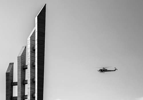 helicopter grayscale photography of helicopter near the building aircraft