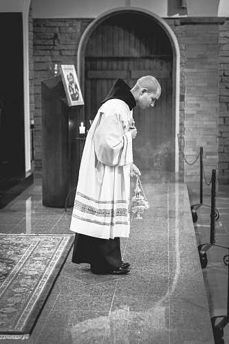 person grayscale photography of man doing vow on stage human