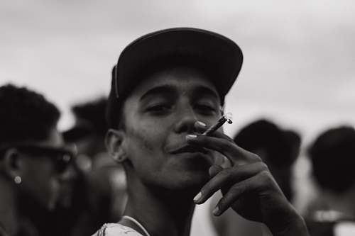 people grayscale photography of man smoking human