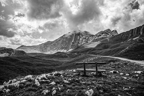 furniture grayscale photography of mountain bench