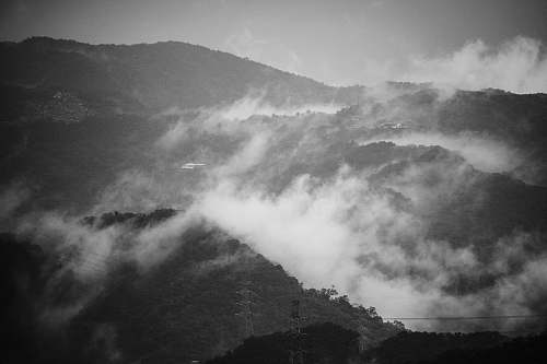 nature grayscale photography of mountain with clouds grey