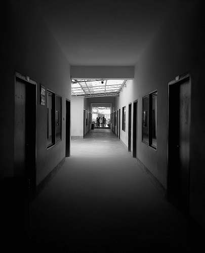 human grayscale photography of pathway between rooms corridor