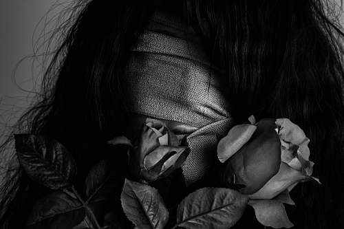 human grayscale photography of woman covered by strap skin