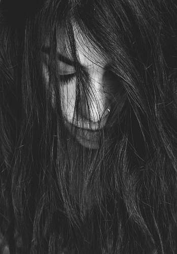 face grayscale photography of woman looking down woman