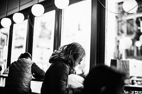 human grayscale photography of woman sitting beside man people