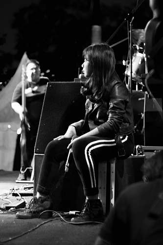 person grayscale photography of woman sitting on box human