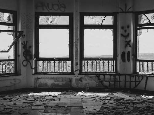prison grayscaled photo of vandalized room porch