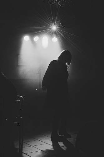 grey grey-scale photo of a person in a stage close-up photography lighting