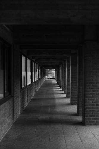 grey grey scale photography of pathway corridor