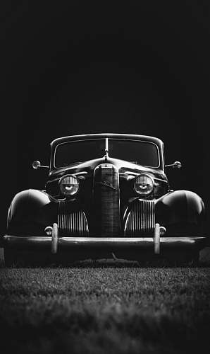 car greyscale photo of classic vehicle on ground vehicle