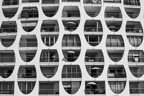 human greyscale photo of high-rise building home decor