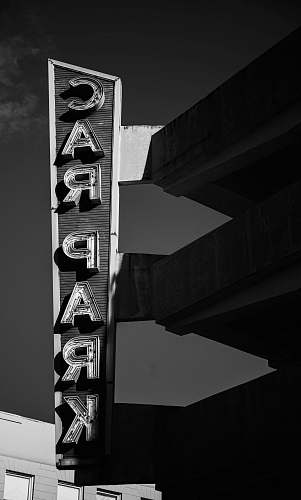 building greyscale photography of car park signage road