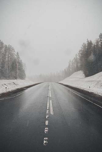grey highway between snow nature