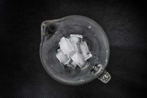 grey ice cubes inside clear glass pitcher ice