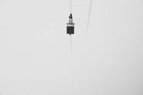 grey low-angle photography of cable car under gray skies zugspitze