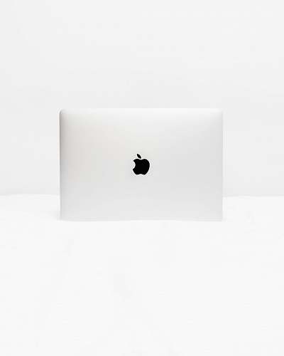 minimal MacBook White open on white surface computer