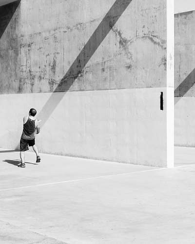 human man by a cement wall person